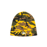 A Stussy beanie hat featuring a yellow, green, and brown camouflage pattern with a small white embroidered Stussy logo on the front, set against a plain off-white background.