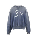 Blue sweatshirt with 'Saint' text on a white background